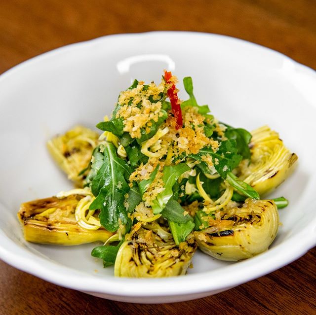 April means Artichoke season! Our simple insalata di carciofi beautifully highlights this spring ingredient, with grilled artichokes, arugula, Pecorino Romano and crispy herb breadcrumbs #ferocenyc